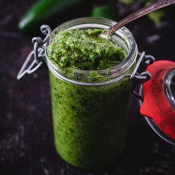 close up on jar of yemenite hot sauce with spoon