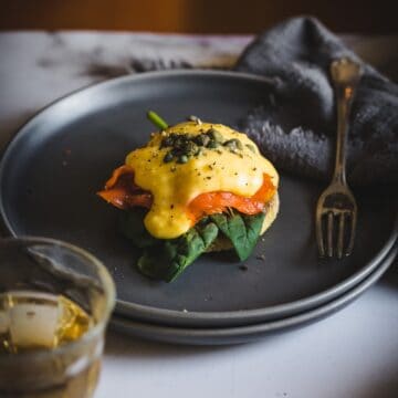 close up on eggs benedict with tea cup